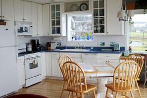 Fully equipped kitchen has gas stove. Garden window.