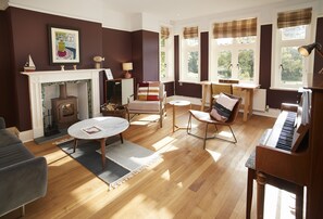 Ground floor: Sitting room with another wood burning stove and beautiful piano