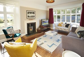Ground floor: Comfortable living room with a wood burning stove, television and DVD player