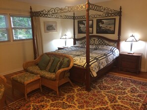 Settee with footstool in front of bed