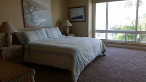 King-size master bed. Flat screen TV in room.
