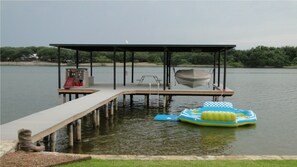 Picnic table, play fort with slide, & 2 ladders into water. Boat slip available.