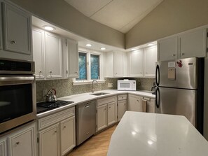 Kitchen with new quartz countertops, breakfast bar and island.