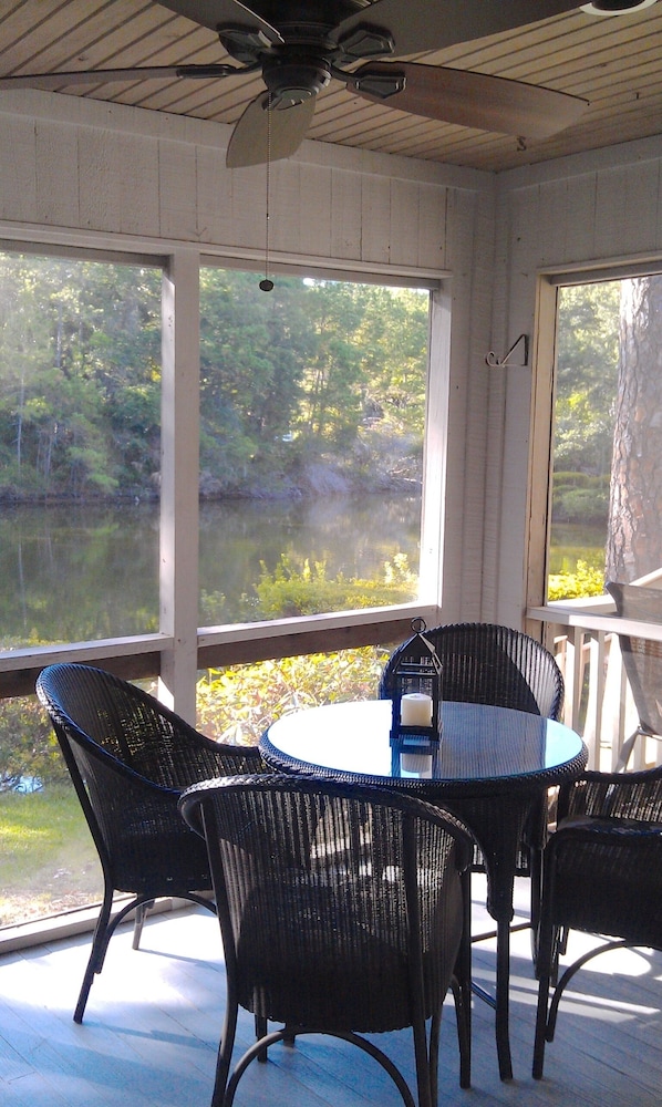 Lounge on the screened porch overlooking the lagoon