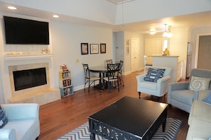 Large living room with beachy decor and a flat screen TV