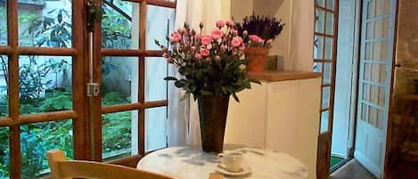 French window and French doors opening onto garden courtyard.