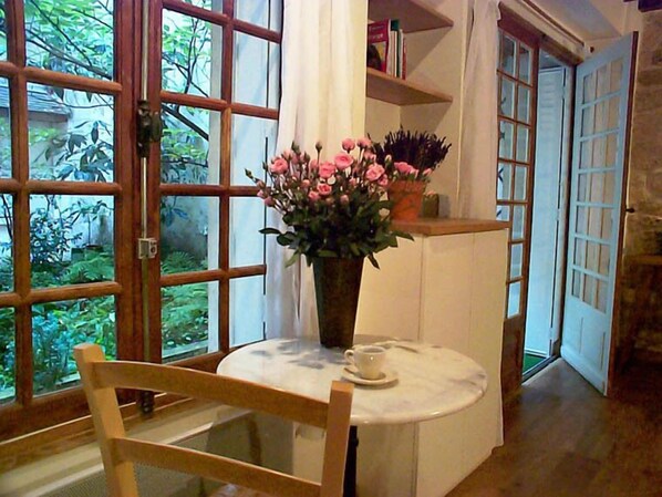 French window and French doors opening onto garden courtyard.