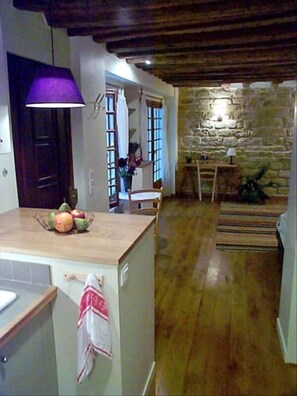 View from the kitchen to front door, windows, French doors.