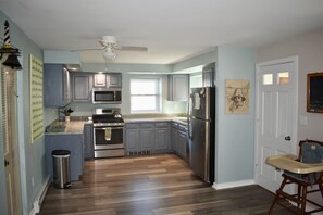 First floor kitchen with updated appliances and new floor (2023)