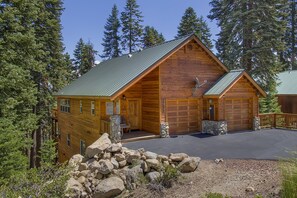 Charming front porch with two car garage