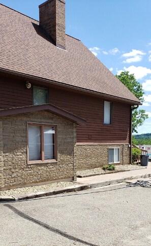 Basement entry from the asphalt driveway.  Back deck with ramp to main floor.