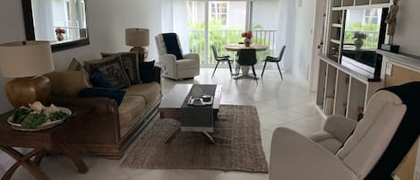 Living room with 2 Lazy Boy rockers , sliding stacking doors to open the room . 