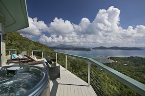 Deck hot tub ,comfortable dining set and cushioned  chaises to enjoy the view.