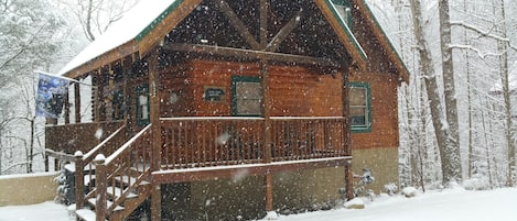 Front of cabin during snow flurries