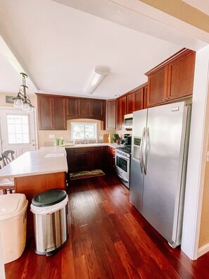 Fully stocked kitchen. Corian countertops. Beautiful stainless appliances. 