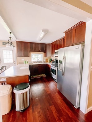 Fully stocked kitchen. Corian countertops. Beautiful stainless appliances. 