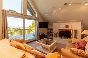 Living room with views out to Lake Michigan. Note: fireplace is not operational.