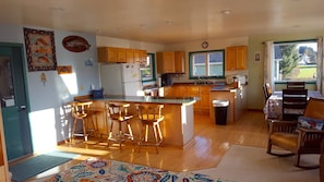 Cozy kitchen with every cupboard full of plates, cooking pots, bowls, utensils