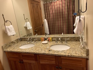 New granite with double sinks, across from deep soaking tub