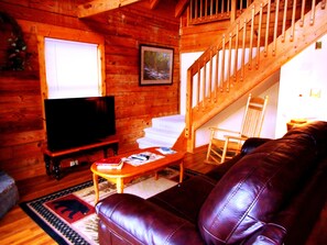 Living Room's 50' HDTV with 200+ channels, Leather Sleeper Sofa & Wood Fireplace