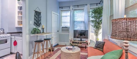 Living room with several cozy seating arrangements. The table on the left folds up if you want a bit more room