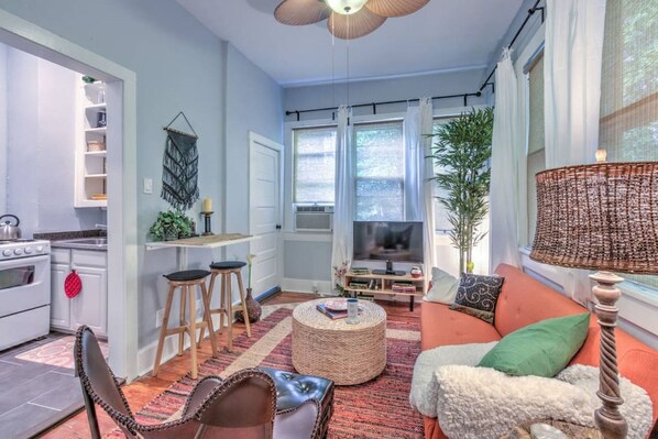 Living room with several cozy seating arrangements. The table on the left folds up if you want a bit more room