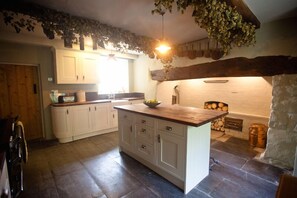 farmhouse kitchen with original floor and inglenook.