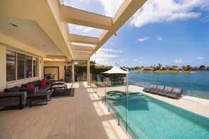 Parents can supervise children in the pool and lake , relaxing with cocktails 