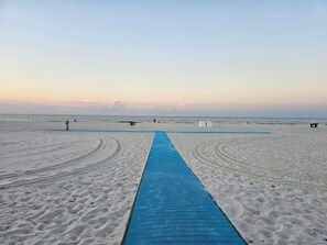 Blue mat makes it easy for strollers, wheelchairs, and beach carts.