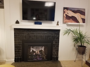 Fireplace with blower  heats up the apartment and keeps it cozy.