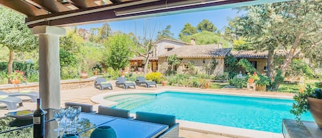 Vista de la piscina desde el porche del jardin.