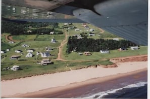 Grand Chalet is to the left of the beach path past grove of trees on the right