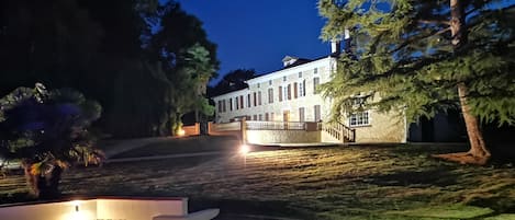 view of the house from the pool area at night fall