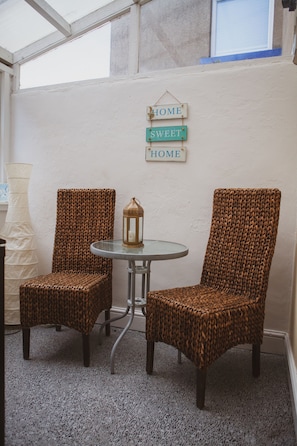 Kitchen leads to undercover seating area. There is also a washer and freezer.