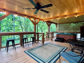 You’ll love the huge outdoor living space, complete with string lights and a fan