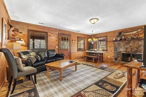View of living and dining areas adorned with hunting and fishing decor perfect for the true sportsman.