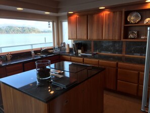 Black granite counters, custom maple cabinets and imported stone back splash