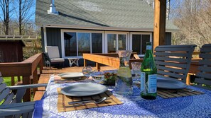 Enjoy dining outdoors on the large deck overlooking the yard. 