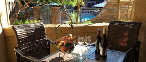 Enjoy a glass of wine on our lovely patio facing pool and clubhouse!