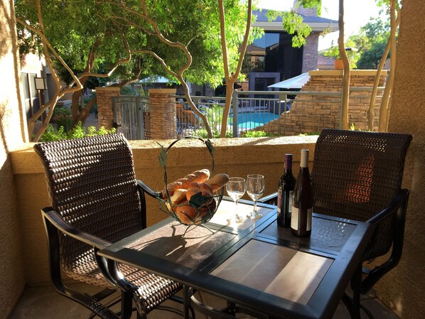 Enjoy a glass of wine on our lovely patio facing pool and clubhouse!