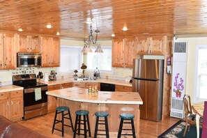 The modern rustic-style kitchen offers a spacious place to cook and enjoy a meal.