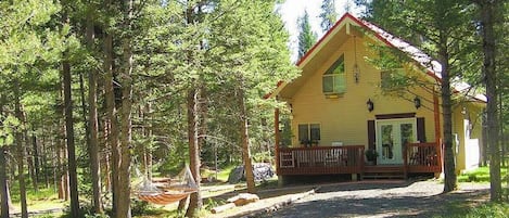 From the front porch, you can hear the birds singing and the wind rushing through the fragrant pines.