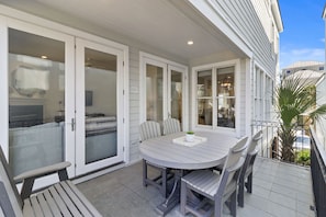 Enjoy a drink on the balcony with outdoor table and seating