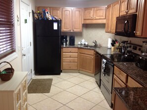 Updated kitchen! Granite countertop, tile, & back splash. The main entrance.
