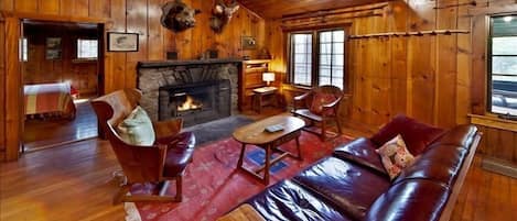 Living area with fabulous stone wood burning fireplace, Great vintage furniture