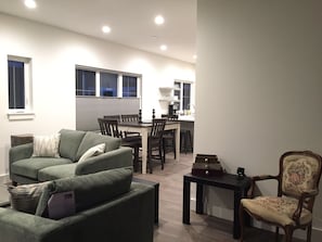 Entry view into living room, dining area and kitchen beyond