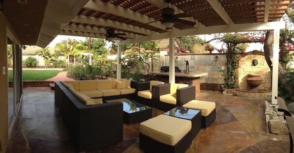 patio with wicker sofa sets, BBQ island with granite tile, fountain