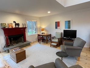 Sitting area has a desk and a working fireplace