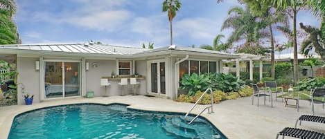 Sparkling lagoon pool with waterfall hot tub and perfect entertaining set up