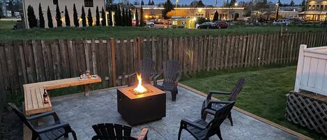 Outdoor fire-pit area with 6 comfortable chairs & bench.  